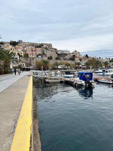 a marina with boats in the water and buildings at Thomais Guesthouse in Kavala