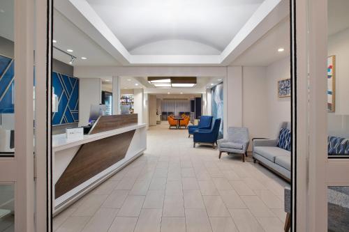 an office lobby with chairs and a reception desk at Holiday Inn Express Hotel & Suites Grand Rapids-North by IHG in Grand Rapids