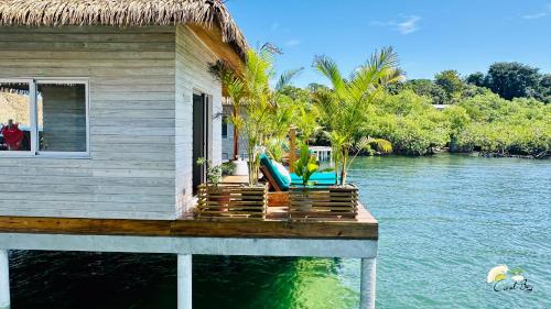 a house on a dock on the water at CoralBay Bungalows Solarte in Solarte
