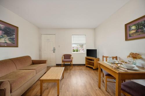 a living room with a couch and a table at Affordable Suites Conover / Hickory in Conover