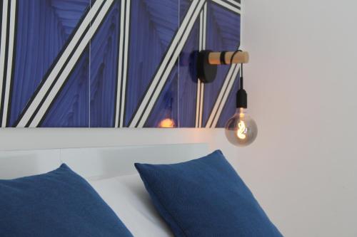 a room with blue pillows and a window at Il Melograno in Costa d'Amalfi - romantic experience in Vietri sul Mare