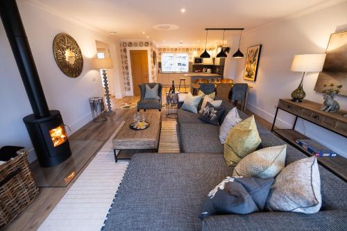 a living room with a couch and a fireplace at Heather Lodge in Comrie