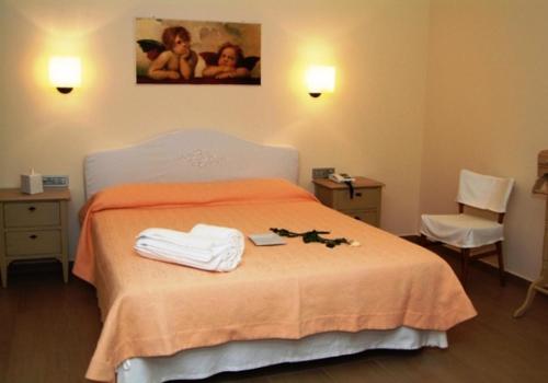 una camera da letto con un letto e asciugamani di Hotel Piccolo Principe a Villongo SantʼAlessandro