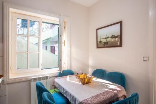 a room with a table and chairs and a window at Luxury Apartments Montesan in Sveti Stefan