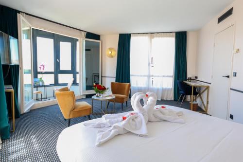 a hotel room with two swans towels on a bed at Best Western Hotel du Pont Wilson in Lyon