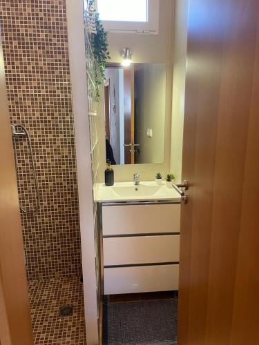 a bathroom with a sink and a shower at Refugio da Mina in Minas de São Domingos