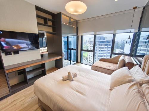 a bedroom with a bed with a teddy bear on it at Republica del Salvador Coliving Ecuador XOE in Quito