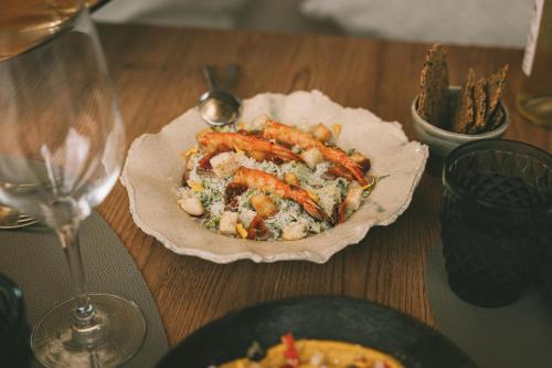 a table with a plate of food and a glass of wine at Predi Son Jaumell Hotel Rural in Capdepera