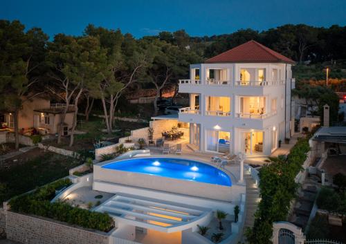 an aerial view of a house with a swimming pool at La Villa - BEACHFRONT - INFINITY HEATED POOL - NEW in Sutivan