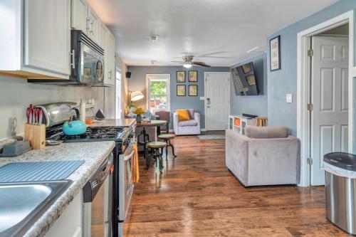 a kitchen with a counter top and a living room at Cheerful 2-Bedroom with convenient Expressway access in Springfield