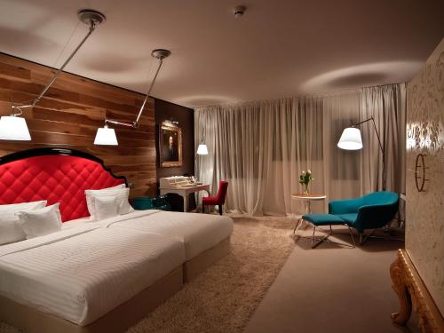 a hotel room with a bed and a desk and chairs at Graffit Gallery Design Hotel in Varna City