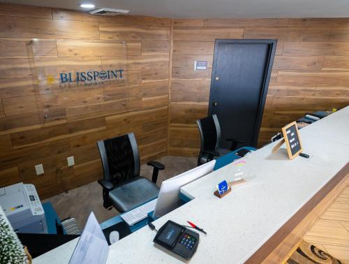 an office with a desk with a sign on the wall at BlissPoint Inn, Kokomo in Kokomo