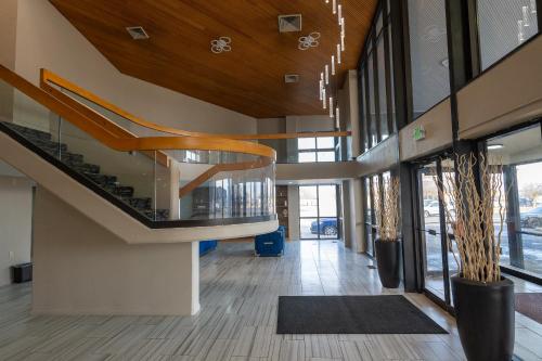 a lobby of a building with a spiral staircase at BlissPoint Inn, Kokomo in Kokomo