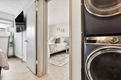 a living room with a washer and dryer at Fully Remodeled Condo Close to Lifts and Bus Stops in Avon
