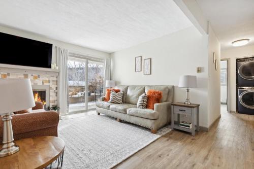 a living room with a couch and a fireplace at Fully Remodeled Condo Close to Lifts and Bus Stops in Avon