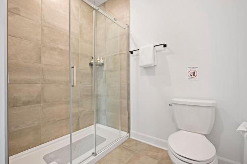 a bathroom with a shower and a toilet at Luxury 5BR Chalet with Sauna, Hot Tub and Game Room in La Conception