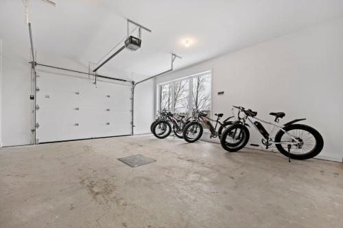 a group of bikes parked in a garage at Luxury 5BR Chalet with Sauna, Hot Tub and Game Room in La Conception