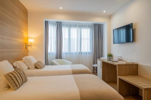 Postel nebo postele na pokoji v ubytování Hostal Menurka
