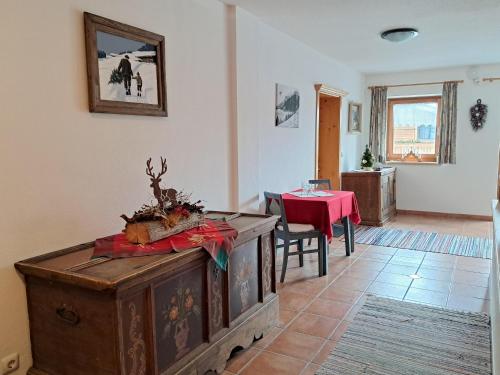 a living room with a table and a red table cloth at Foidlhof - Privatzimmer in Sankt Johann in Tirol