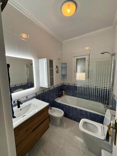 a bathroom with a tub and a toilet and a sink at Villa Veranos, Rojales, Benijofar, Alicante, Valencia in Rojales