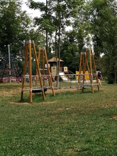 a playground with a bunch of swings in a park at La casa dei poeti in Cervasca