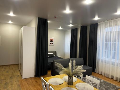 a living room with a couch and a table at Smart House Apartments in Lviv