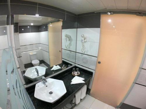 a bathroom with two sinks and a mirror at Romance Regency Club in Sharm El Sheikh