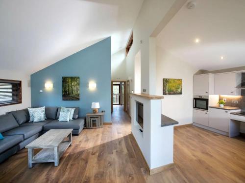 a living room with a couch and a table at Forest of Dean Cabins - Forest Holidays in Staunton