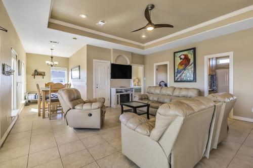 a living room with couches and a dining room at Parrot Head Home in Bolivar Peninsula