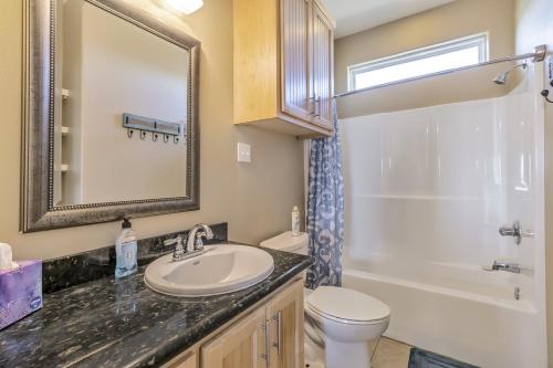 a bathroom with a sink and a toilet and a shower at Parrot Head Home in Bolivar Peninsula