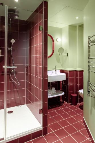 a bathroom with a shower and a sink at Hôtel Mercedes in Paris