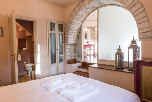 a bedroom with a bed with two towels on it at Kedros - Α Stone maisonette with lounge and 2 bedrooms in Ano Pedina