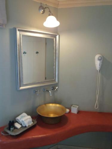 a bathroom with a bowl sink and a mirror at Kedros - Α Stone maisonette with lounge and 2 bedrooms in Ano Pedina
