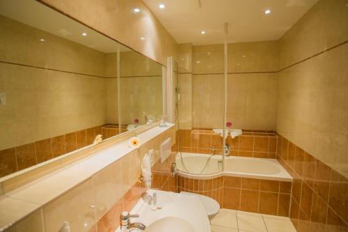 La salle de bains est pourvue d'une baignoire, de toilettes et d'un lavabo. dans l'établissement Parkhotel Idar-Oberstein, à Idar-Oberstein