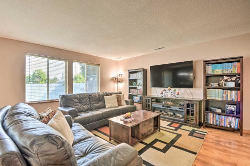 a living room with a couch and a tv at Welcoming Medford Home Near Parks and Downtown! in Medford