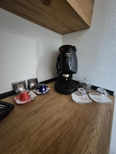 a coffee maker sitting on a counter with plates and cups at Hotel Domestika in Skopje