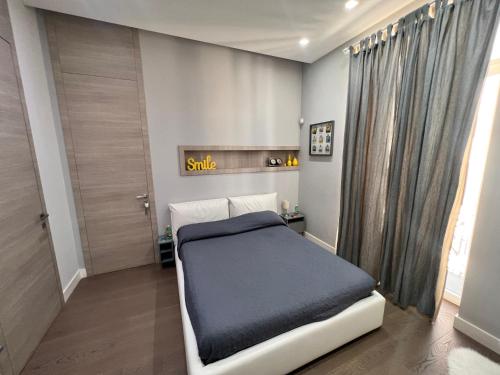 a small bedroom with a bed in a room at RaRoom Luxury R-Aparthotel in Torre del Greco