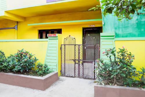 a yellow building with a gate in front of a building at Hotel O Abhilasha in Bhilai