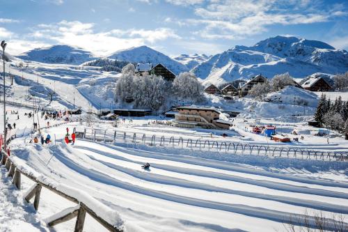 a group of people skiing down a snow covered slope at La casa dei poeti in Cervasca
