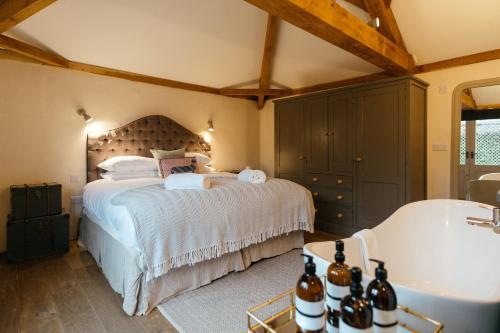 a bedroom with a large bed and a bath tub at Retreat East in Ipswich
