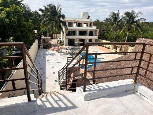 a stairway leading to a building with a swimming pool at Hotel Boutique Villa Ka'an in Calderitas