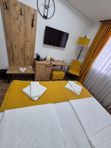 a hotel room with a bed and a tv at Hotel Domestika in Skopje