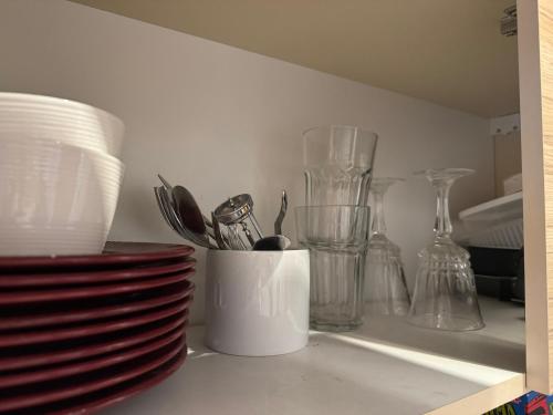 a kitchen counter with plates and utensils in a cup at Freshly renovated bathroom! Luna budget cozy studio apartment Tallinn Juhkentali 42 near city centre airport next to the Bus station in Tallinn