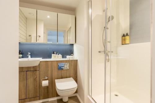 a bathroom with a toilet and a sink and a shower at True Student Manchester Salford in Manchester