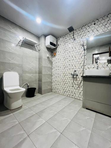 a bathroom with a toilet and a sink at Harvey's Hotels - Gowlidoddy - Near US Consulate in Hyderabad