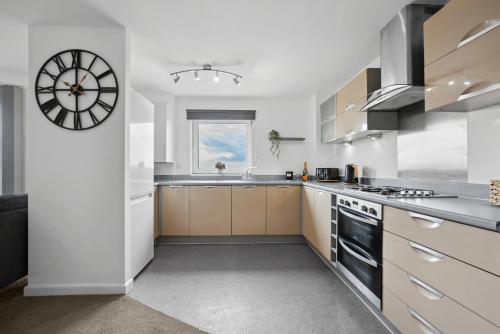 a kitchen with a large clock on the wall at The Pinnacle by Cotels - CENTRAL LOCATION, PARKING, FIBRE WIFI, SMART TV, FULLY EQUIPPED KITCHEN in Northampton