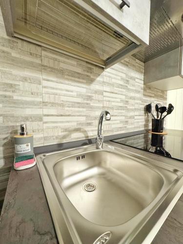 a kitchen sink with a faucet on a counter at CyO Apartment 2 in Boscotrecase
