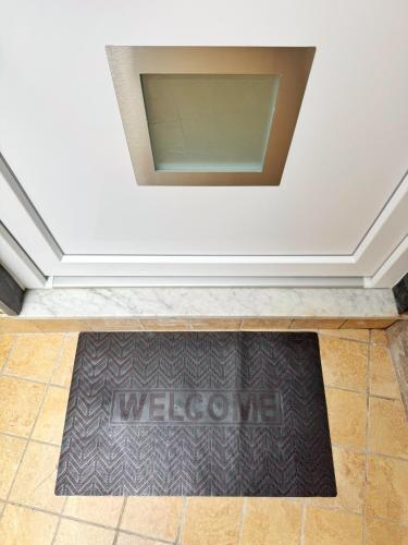 a welcome mat on the floor in a room at CyO Apartment 2 in Boscotrecase