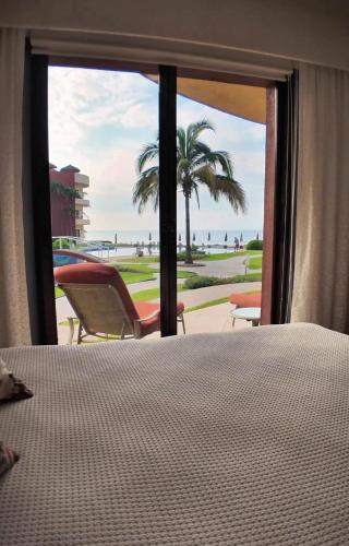 a bedroom with a bed and a view of the beach at Casa Amigos , entire 3 bedroom ground floor condo at Playa Grande Condominium Resort in El Coco