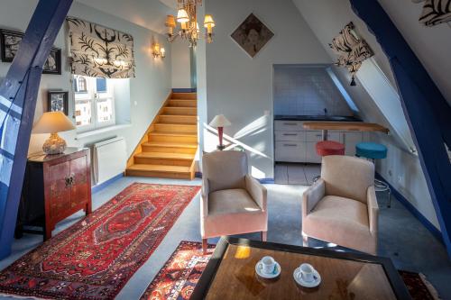 a living room with two chairs and a table at Relais Hôtelier Douce France in Veules-les-Roses